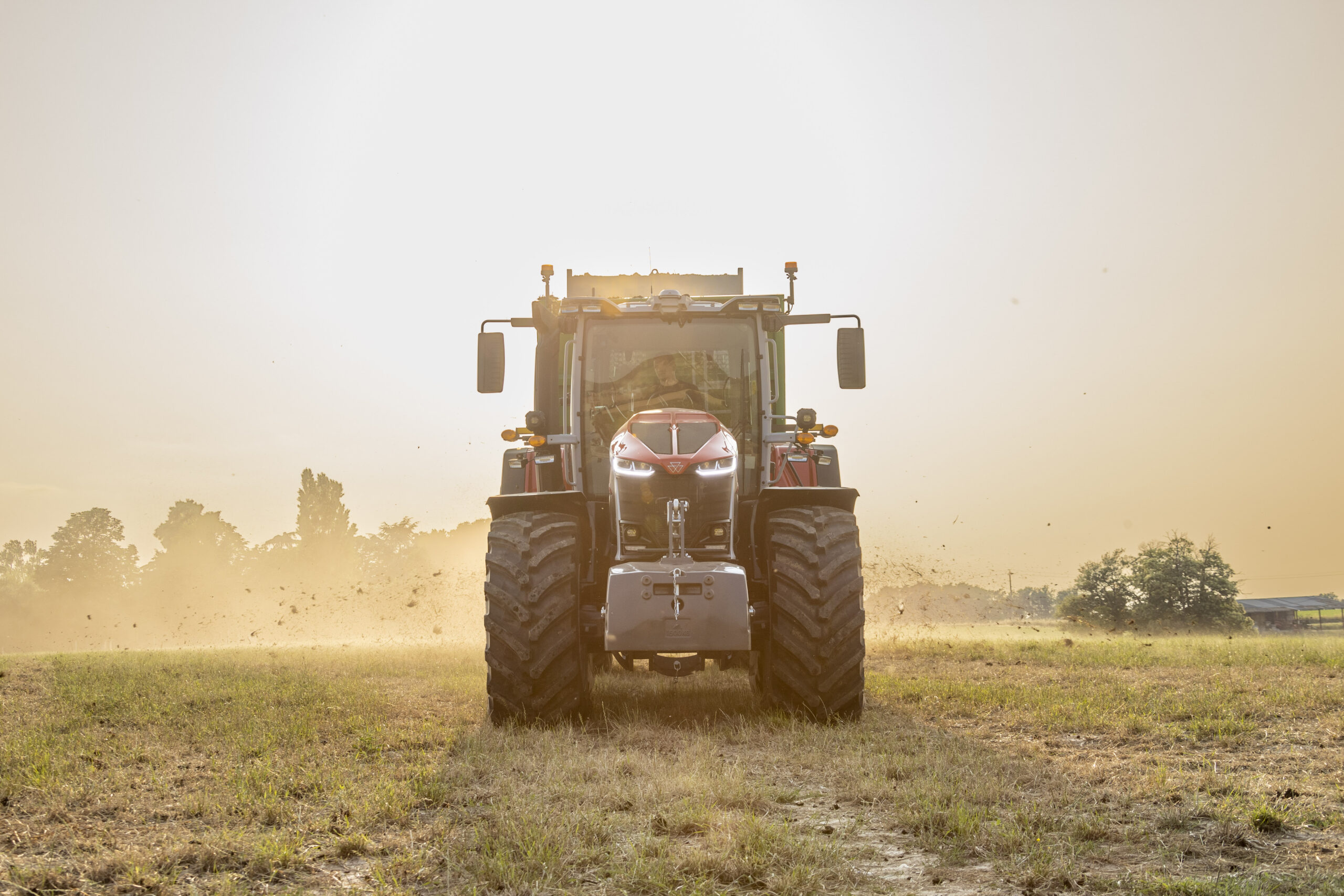 Massey Ferguson 9S Series tractor kicking up dust in a field, showcasing power and performance for AGCO dealers.