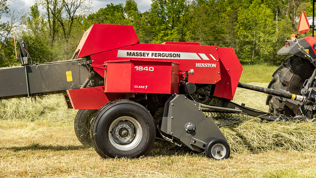 Hesston by Massey Ferguson 1840 small square baler in action, producing tight hay bales with reliable performance.