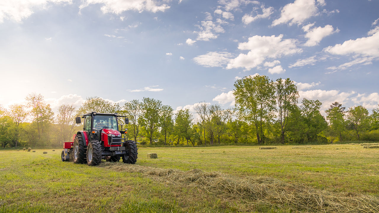 Thumbnail for Massey Ferguson 5700 Series tractor with square baler working in hayfield under sunny sky, ideal for hay and forage operations.