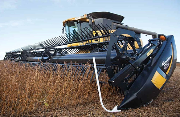 MacDon FD1 FlexDraper header harvesting soybeans, mounted on a Challenger combine, showcasing precision cutting in tough crop conditions.