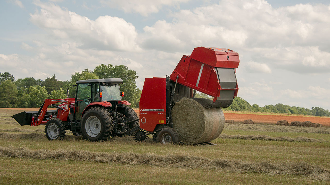 Hesston by Massey Ferguson 1700 Series round baler in hay field, ideal for compact, high-efficiency baling work.