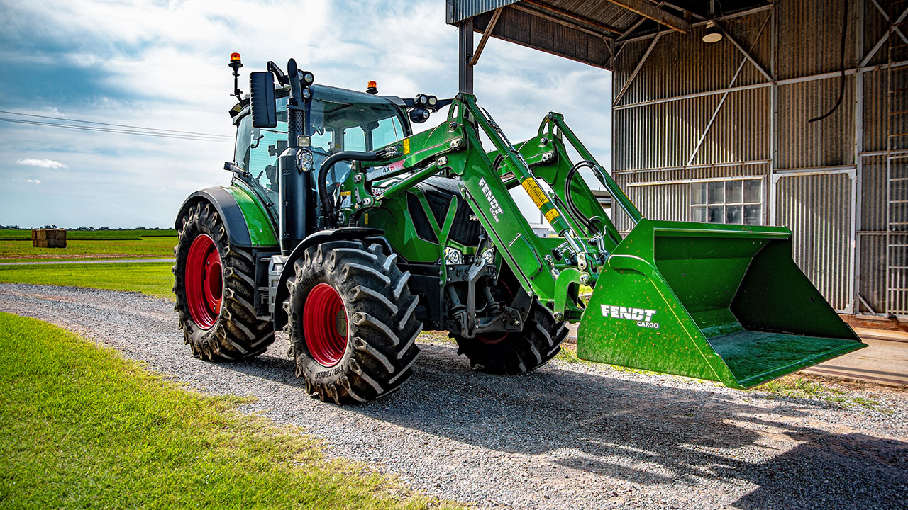 Fendt 300 Vario tractor parked on gravel near farm buildings, ready for versatile AGCO farm work.