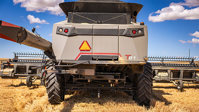 Rear view of Gleaner T Series combine harvester in a wheat field, built for efficient, high-capacity harvesting.