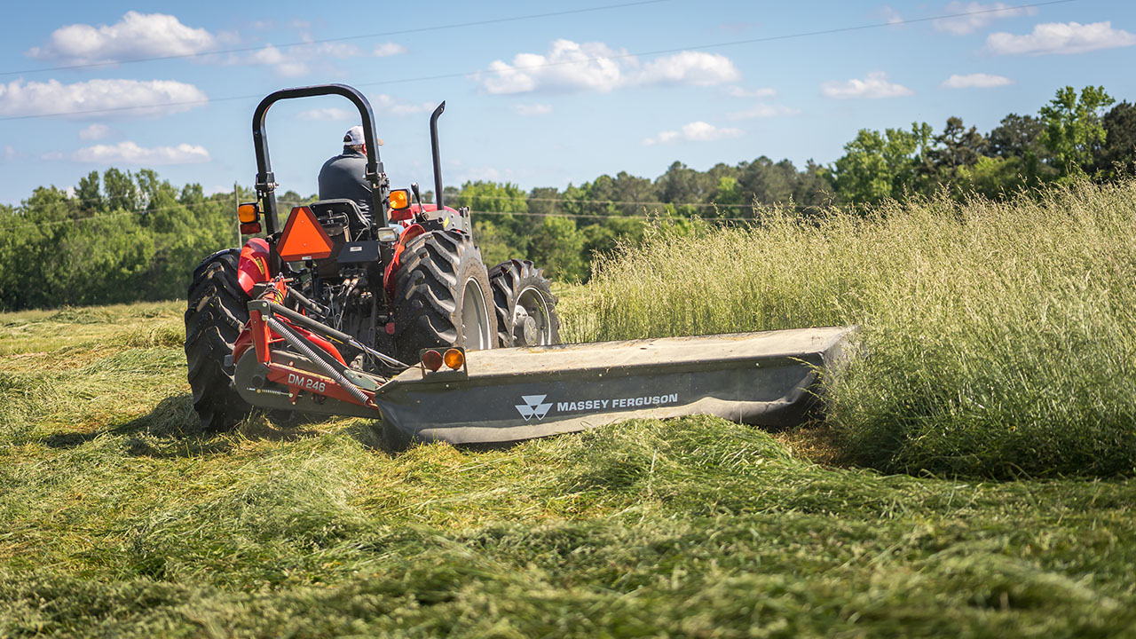 Massey Ferguson tractor with Farmer Series Disc Mower cutting grass in a field