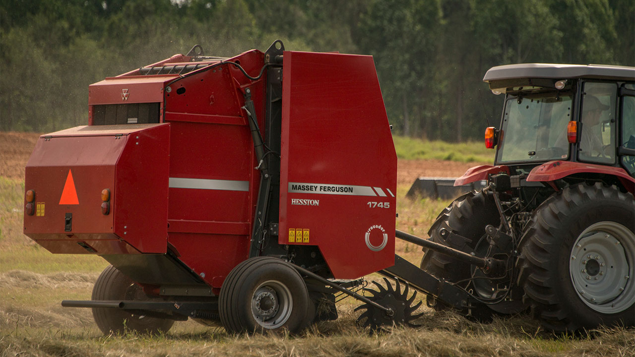 Hesston by Massey Ferguson 1700 Series round baler in operation, ideal for small farms needing reliable hay baling performance.
