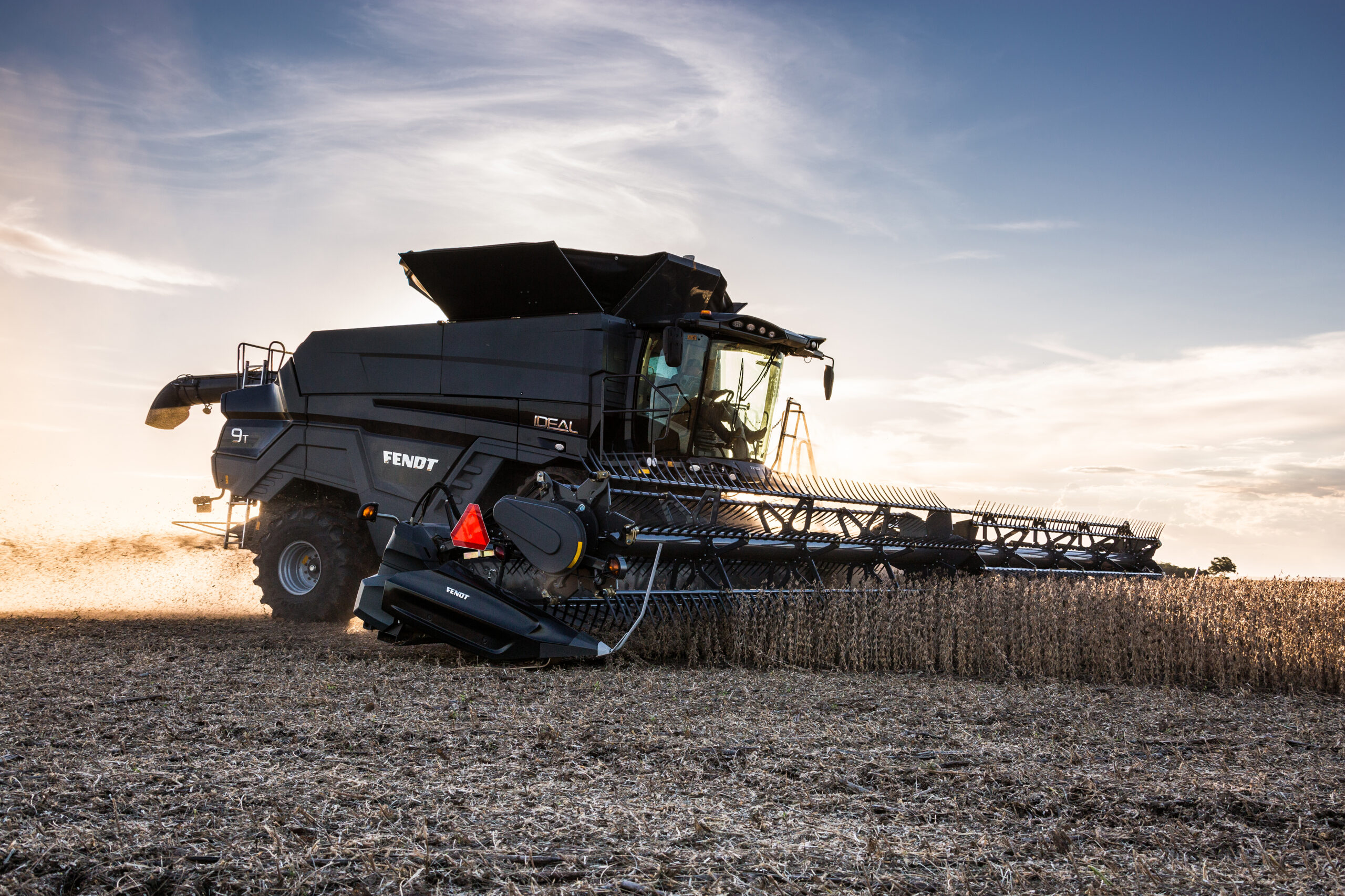 Fendt IDEAL combine harvesting soybeans at sunset with high-capacity header, built for efficiency and precision in the field.
