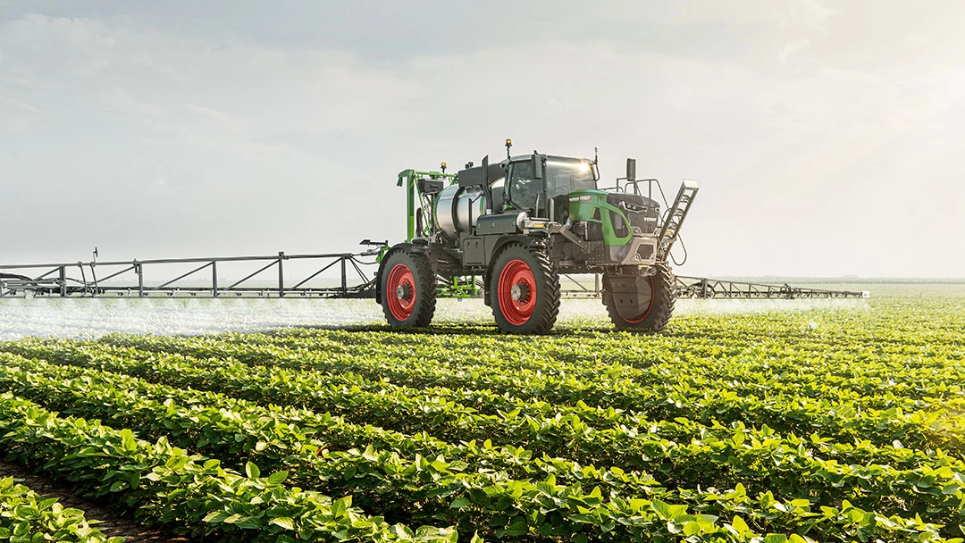 Fendt Rogator sprayer applying crop protection in soybean field with wide boom and high-clearance design.
