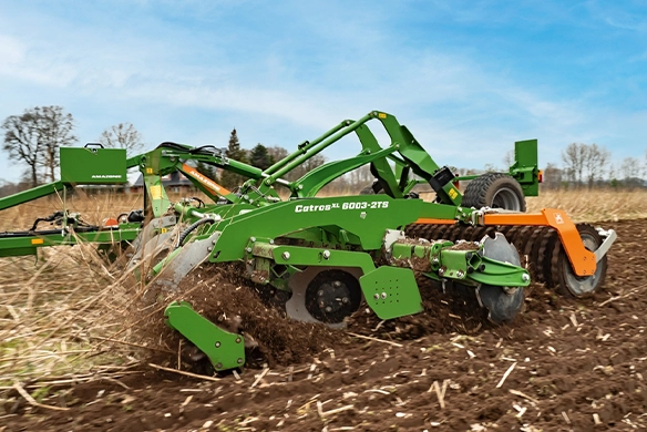 Close up of Amazone CatrosXL 6003-2TS working in the soil.