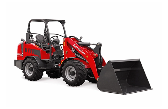 Front perspective of Schäffer 4670Z wheel loader with bucket on ground, emphasizing ease of access and operator visibility.
