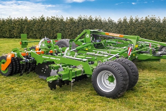 Side view of Amazone Catros+ 8003-2TX disc harrow showing twin transport wheels and folding frame design for efficient transport.