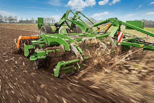 Amazone CatrosXL 6003-2TS disc harrow breaking up crop residue in the field with deep, aggressive disc penetration for optimal soil prep.