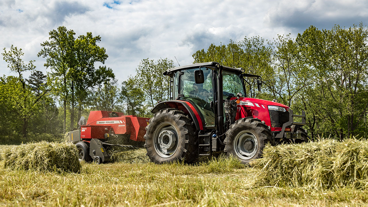 Massey Ferguson 5700 Series tractor baling hay with square baler, ideal for hay production and efficient fieldwork.